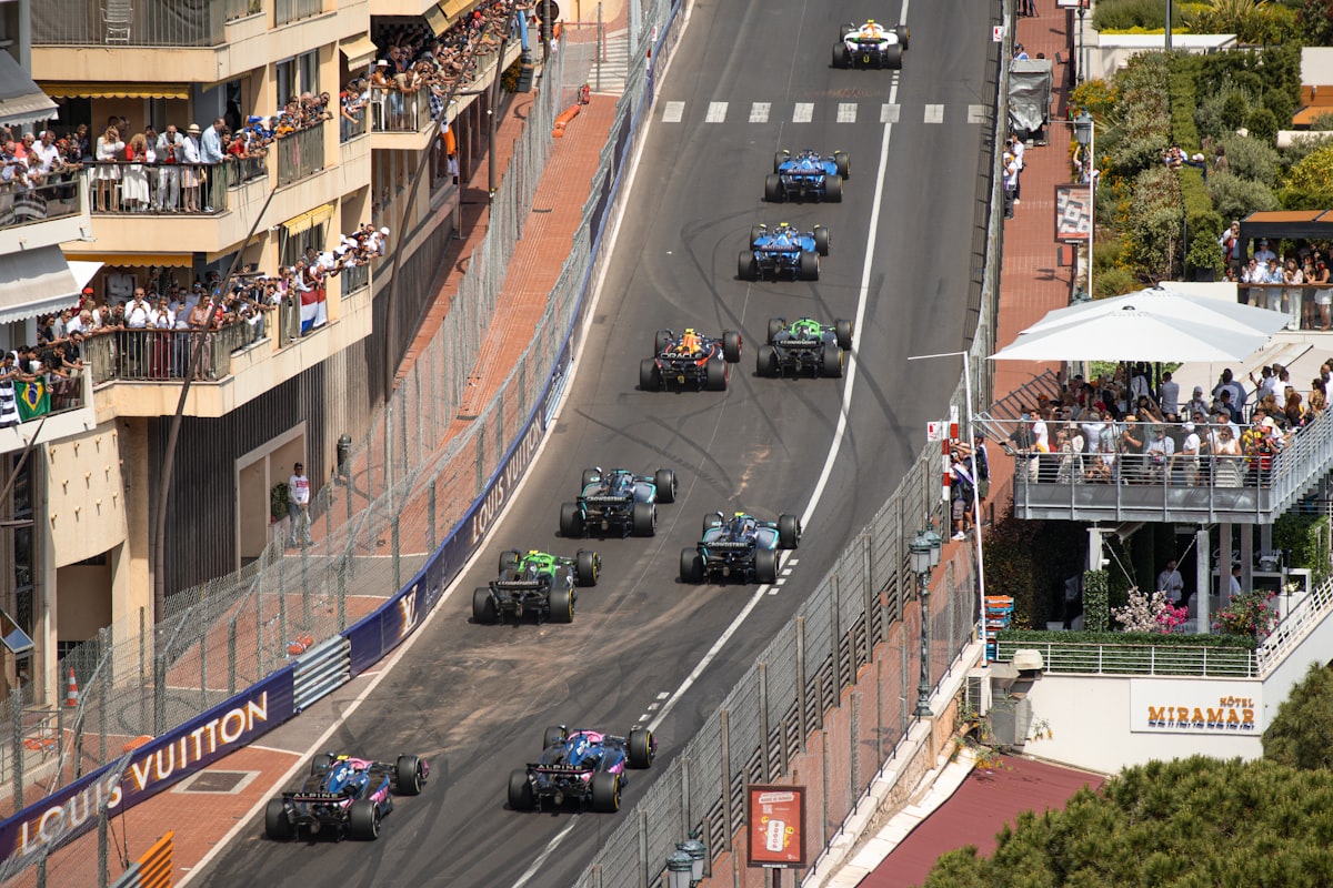Formula 1 cars racing past packed grandstands at the Monaco Grand Prix